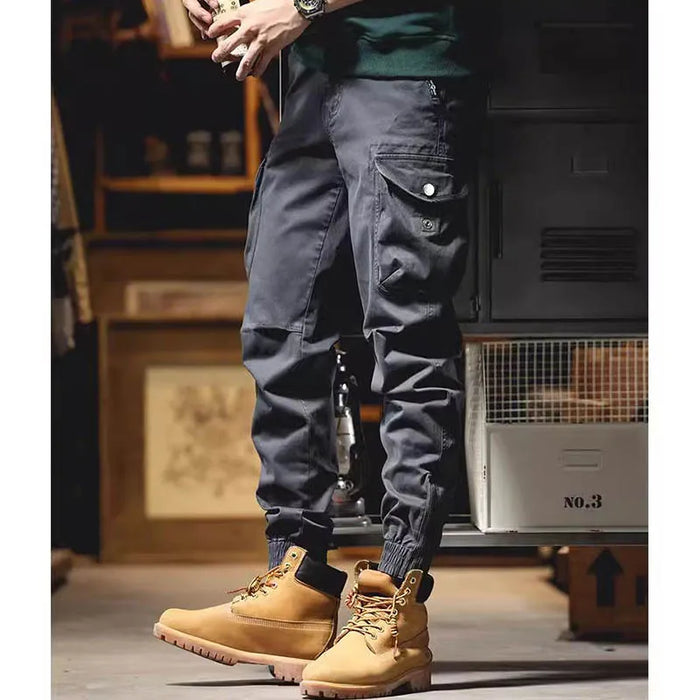 Pantalon cargo à poches zippées et élastiques chevilles